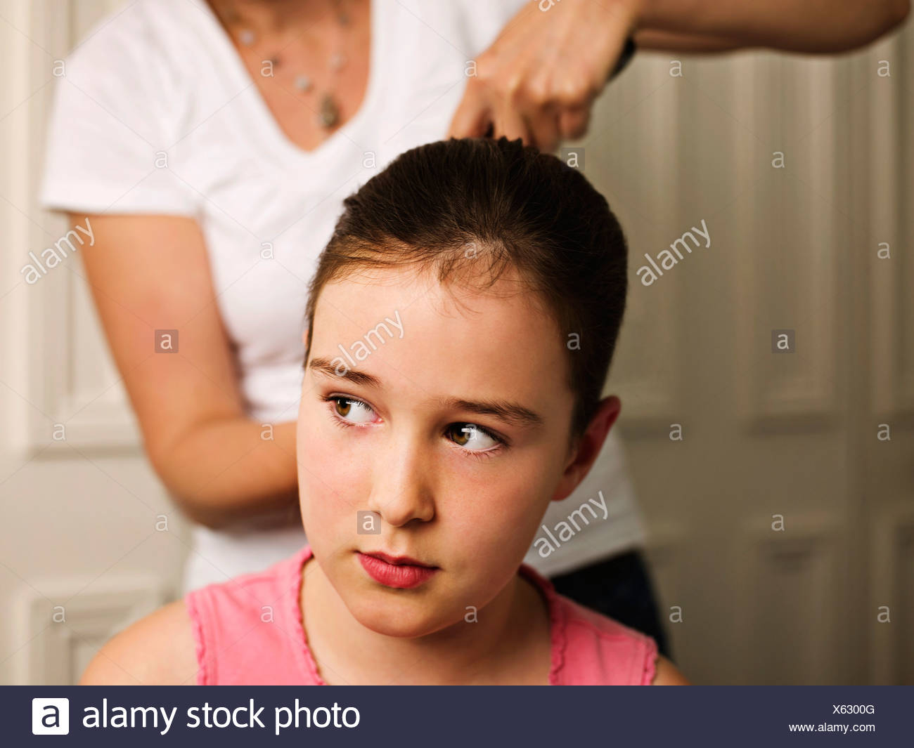 A Woman Tying A Girls Hair Back Stock Photo 279119696 Alamy