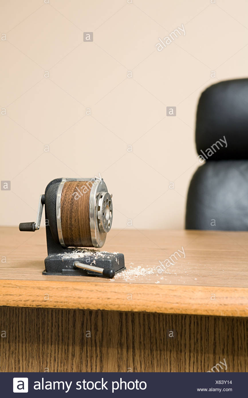 Old Fashioned Pencil Sharpener On Office Desk Surrounded By Pencil