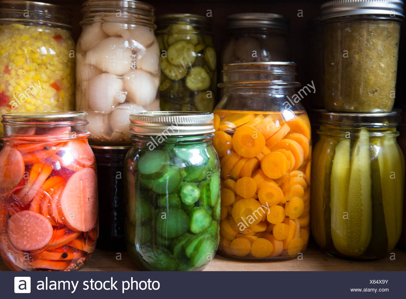 A Woman Cans Jars Of Healthy Food To Supplement What She Receives