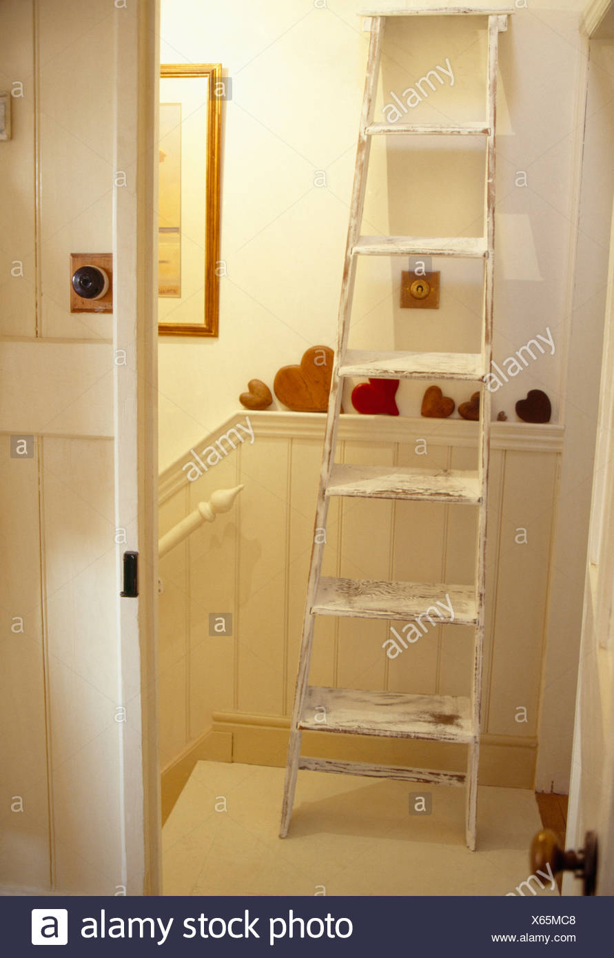 Old White Ladder Against Wall On Traditional Cream Landing