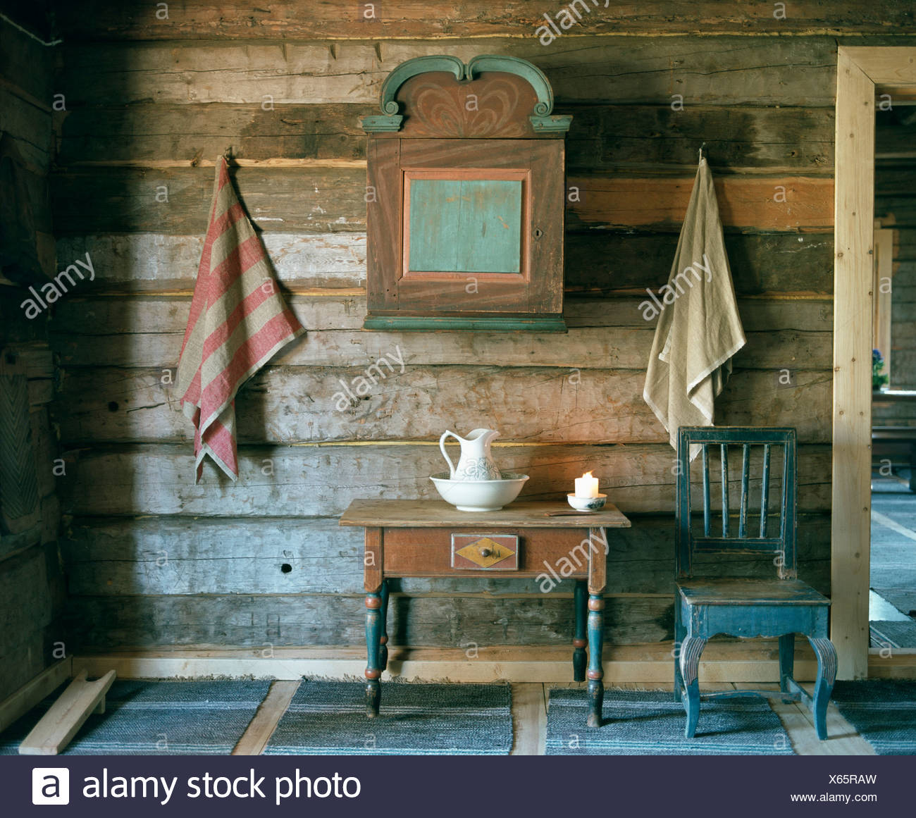 Old Chair And Wooden Table Below Painted Antique Wooden Cupboard In Rustic Panelled Hall Stock Photo Alamy
