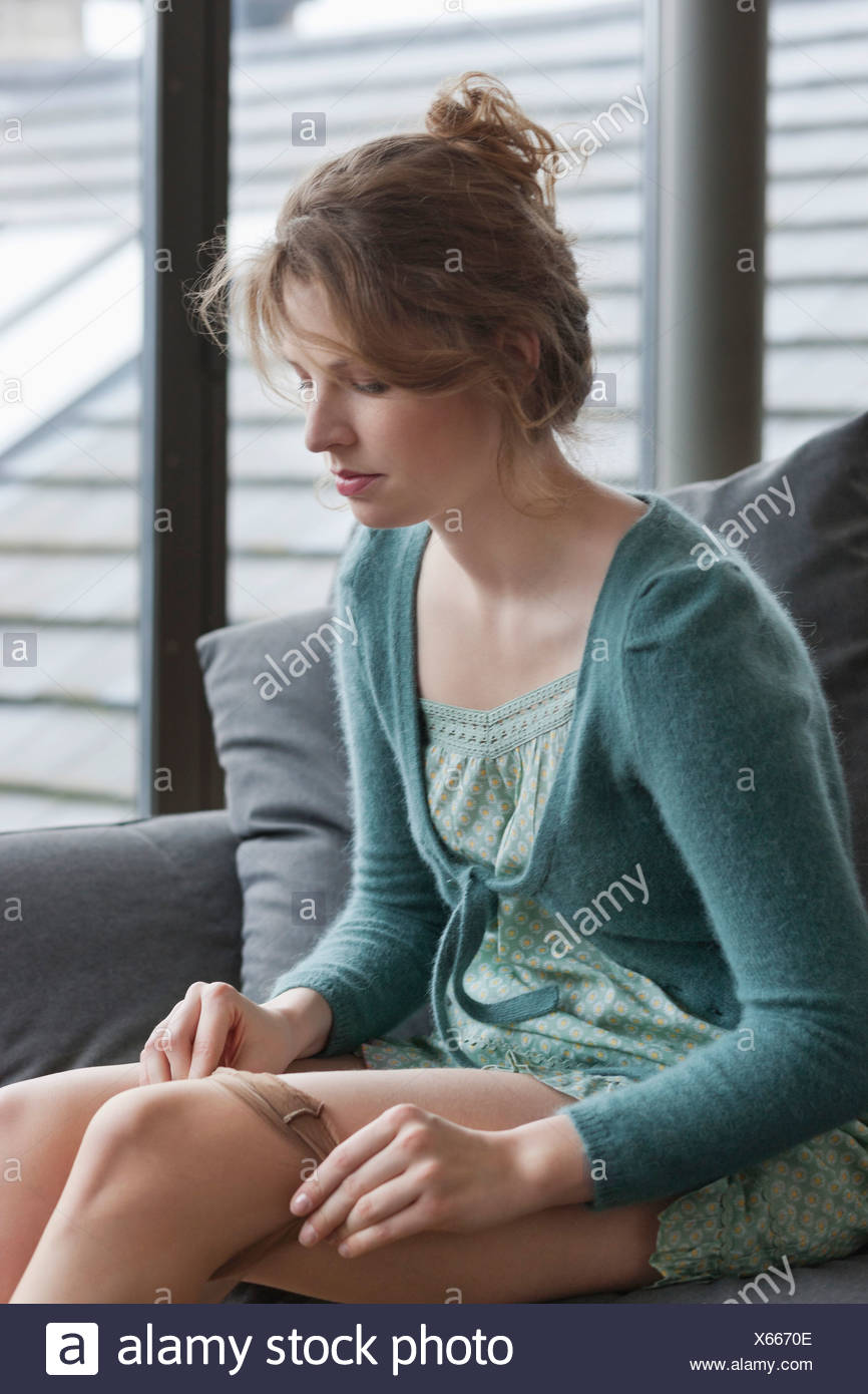 Woman Putting On Stockings High Resolution Stock Photography and Images