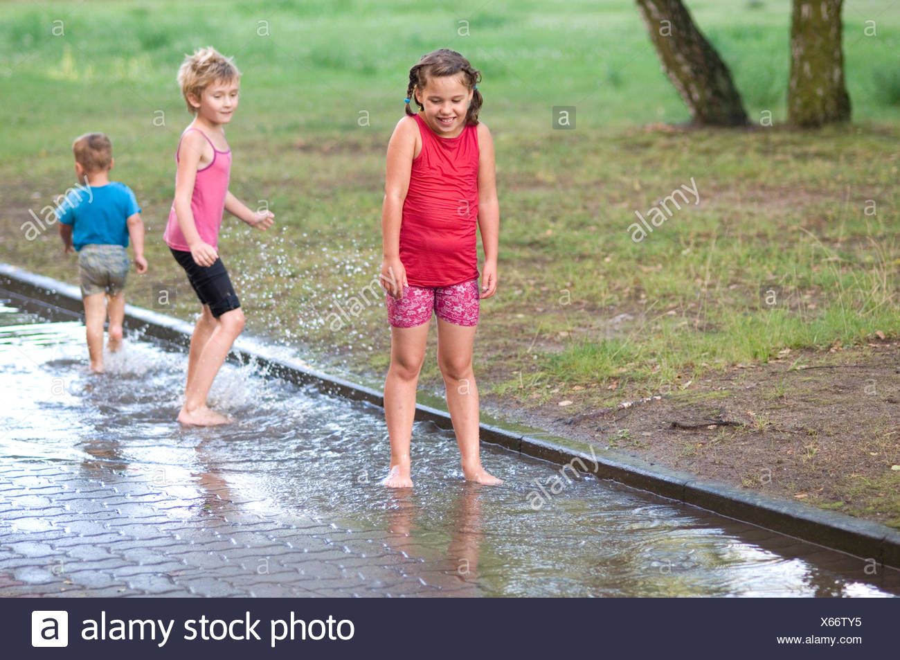 Kids Playing In Rain Stock Photos & Kids Playing In Rain Stock Images