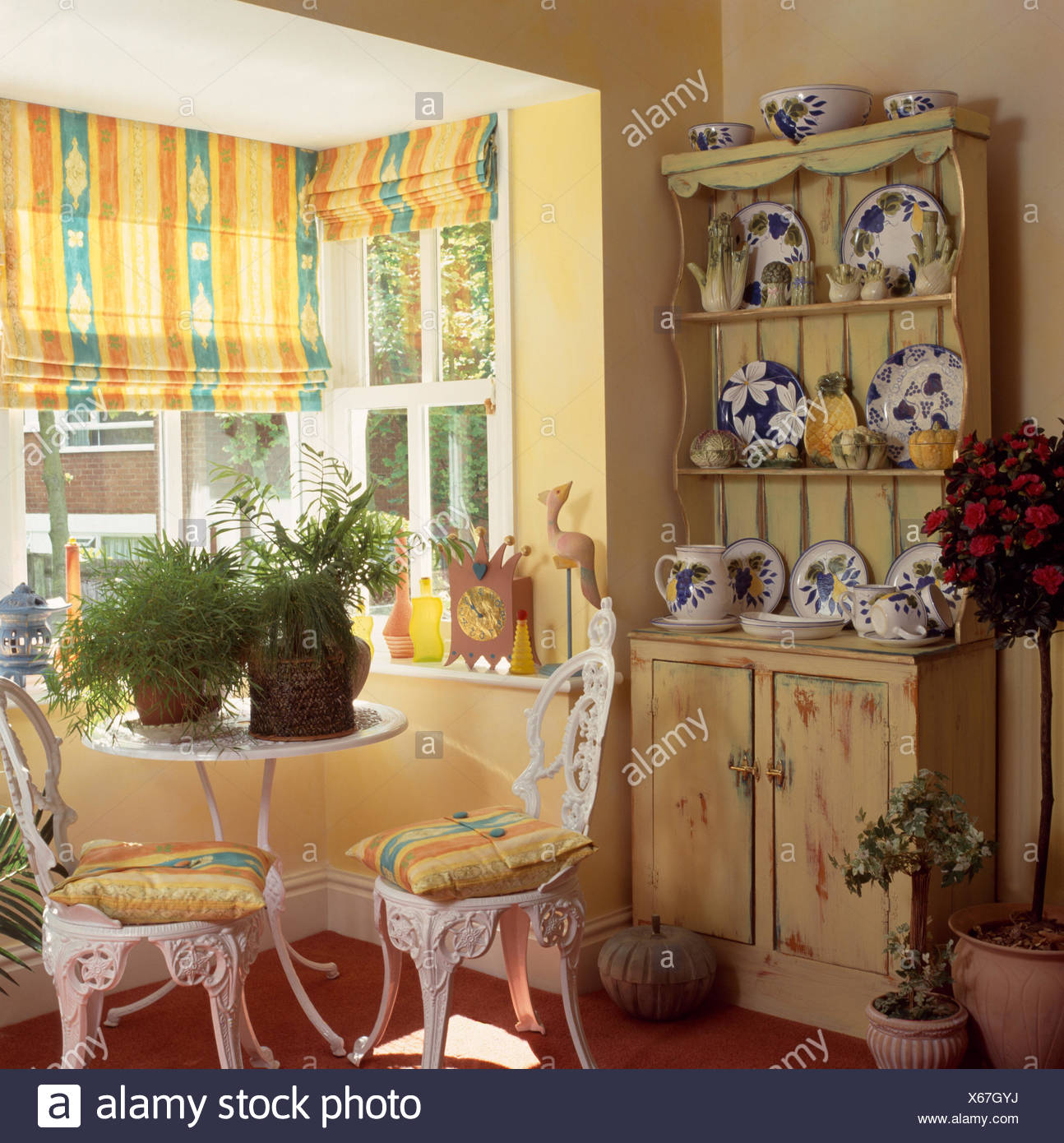 Yellow Blinds On Window In A Nineties Dining Room With White