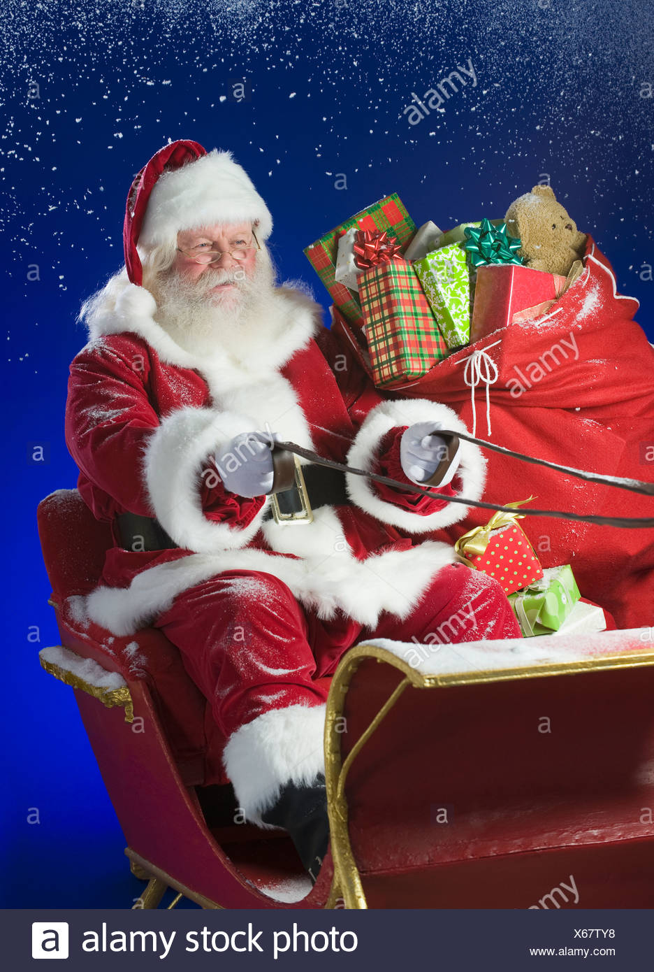 Santa Claus in sleigh with bag of toys Stock Photo ...