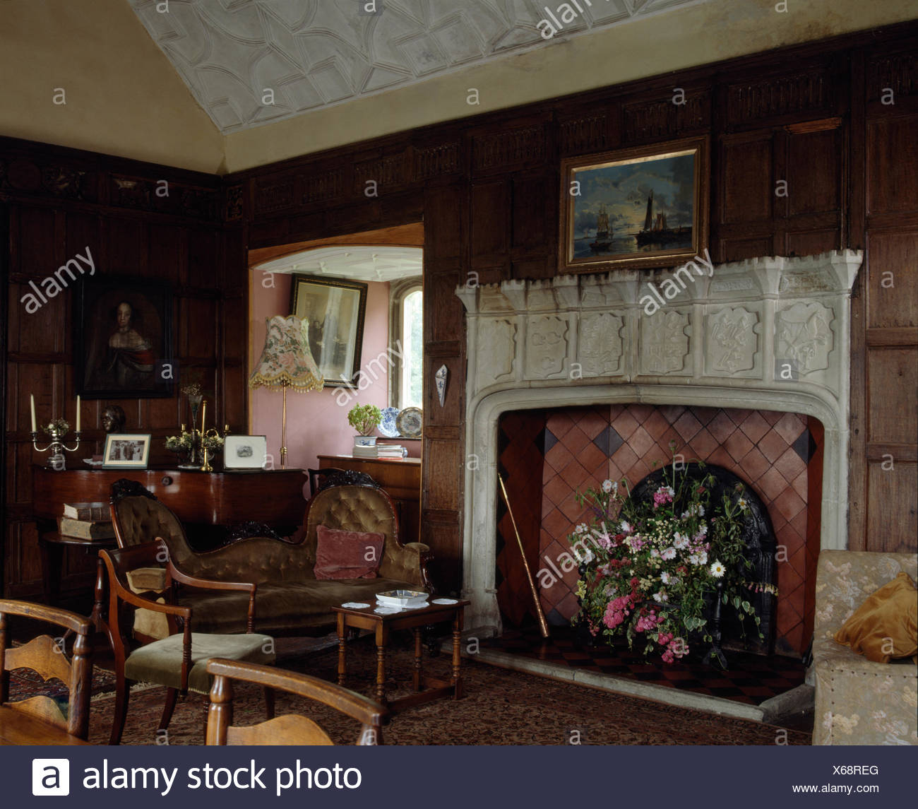 Carved Stone Fireplace In An Old Fashioned Oak Paneled Dining Room