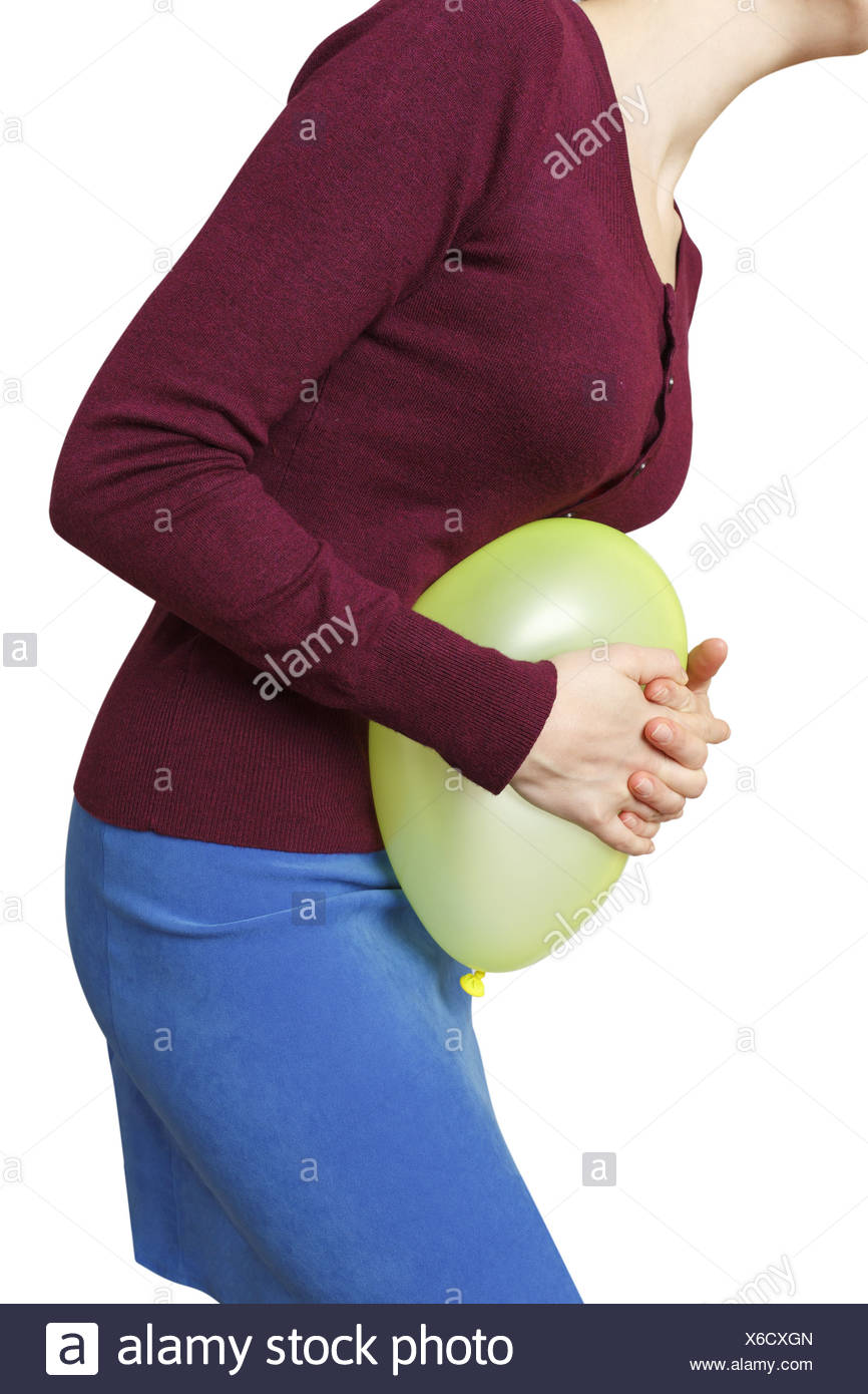 Woman pushing a balloon against her belly, symbolic image for ... Woman pushing a balloon against her belly, symbolic image for ...