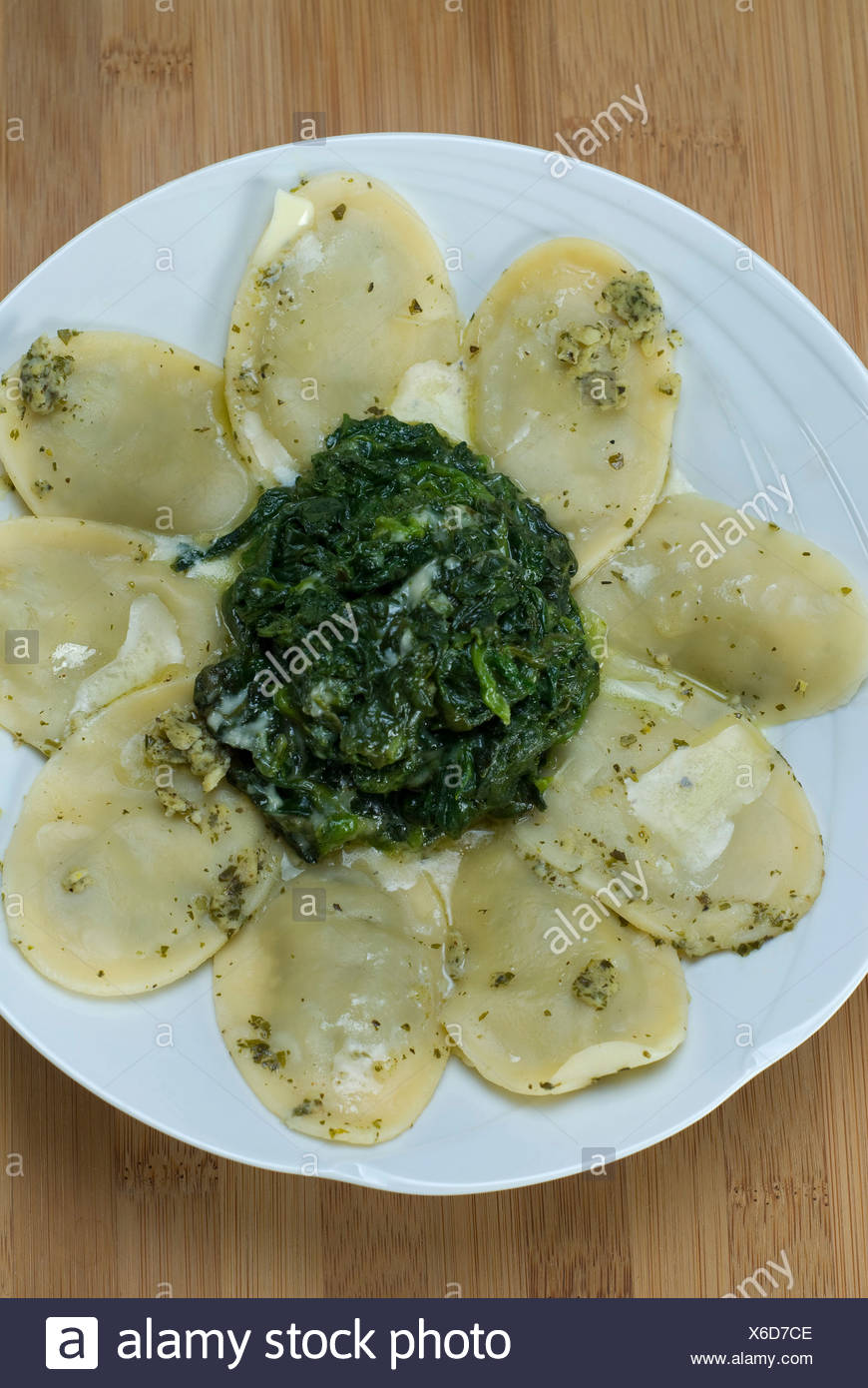Pasta squares filled with ricotta and spinach with gorgonzola cheese Stock Photo