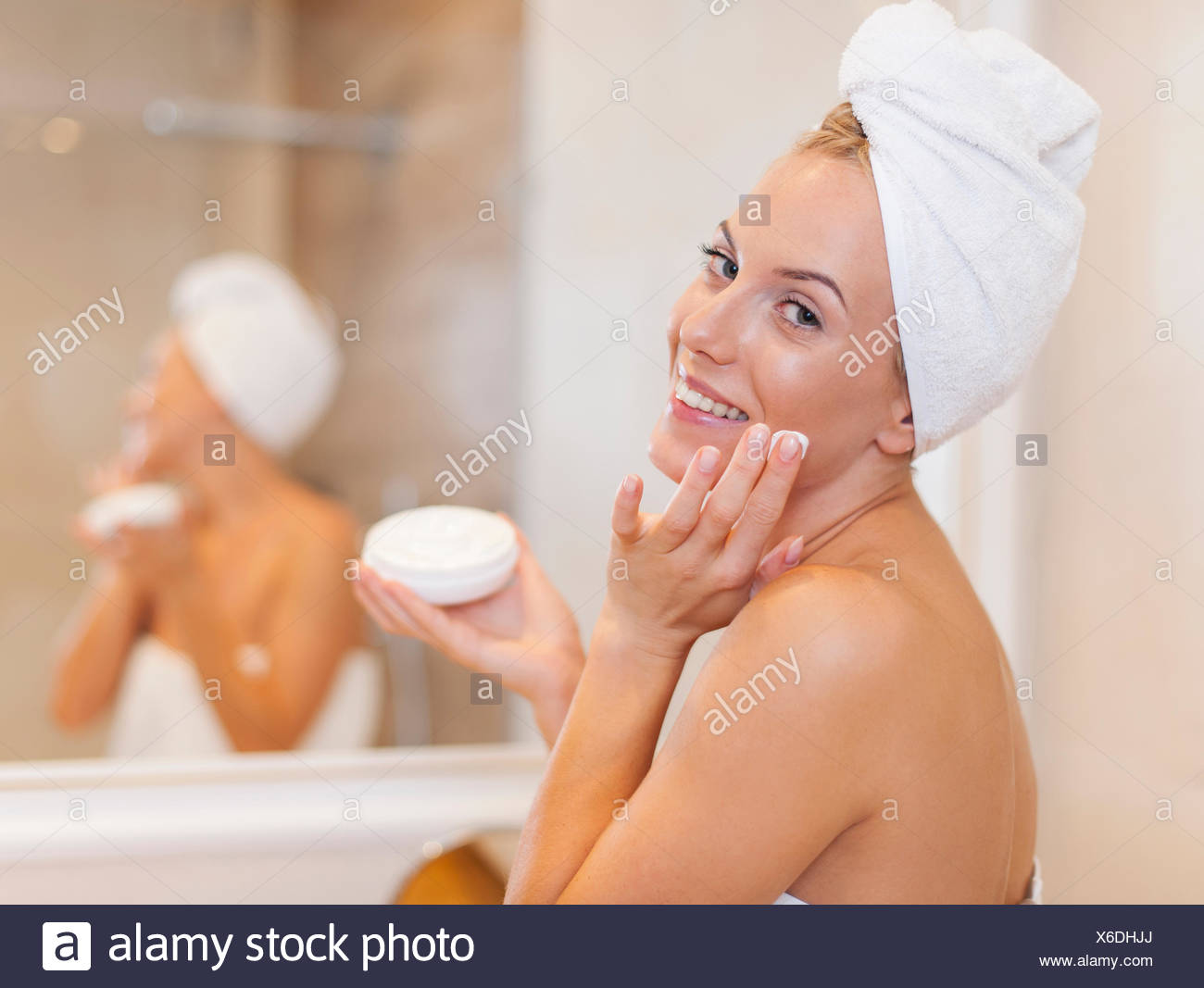 Happy Woman Applying Moisturizer On Face After The Shower Debica