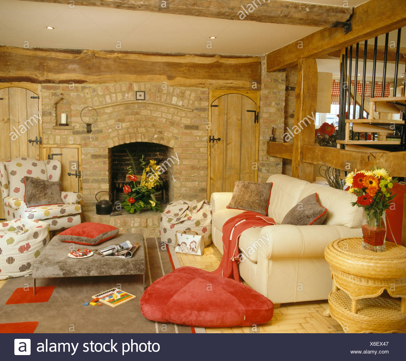 Red Floor Cushion Beside Cream Sofa In Country Living Room With
