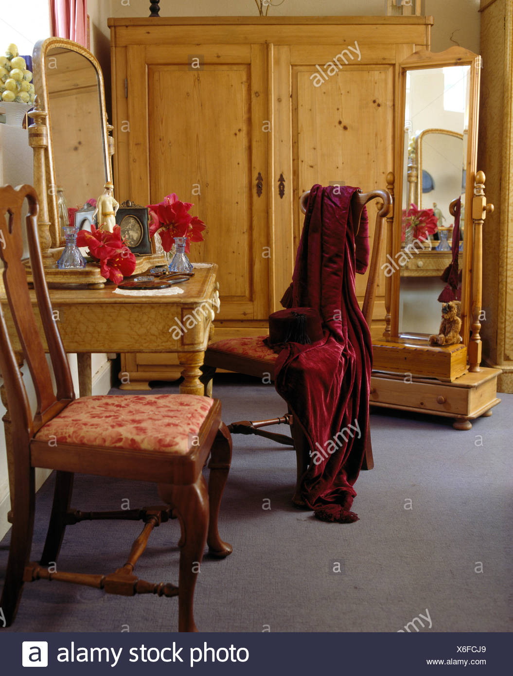 Large Pine Wardrobe And Cheval Mirror In Country Bedroom With Red