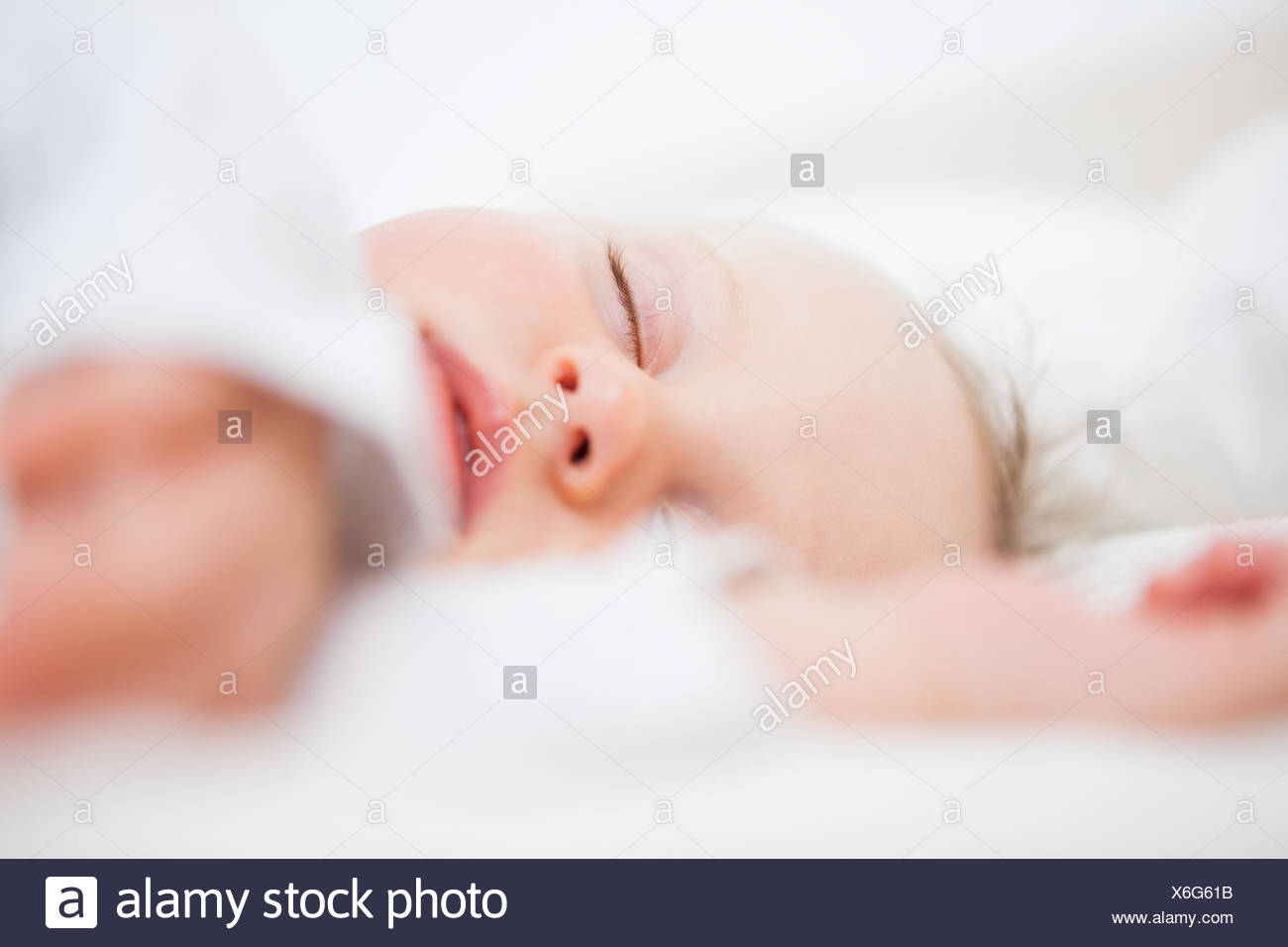 Baby Falling Asleep While Extending Her Arms In A Bedroom