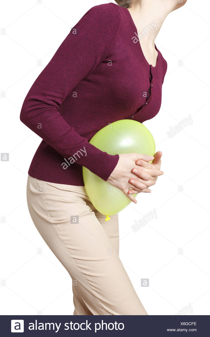 Woman pushing a balloon against her belly, symbolic image for ... Woman pushing a balloon against her belly, symbolic image for ...