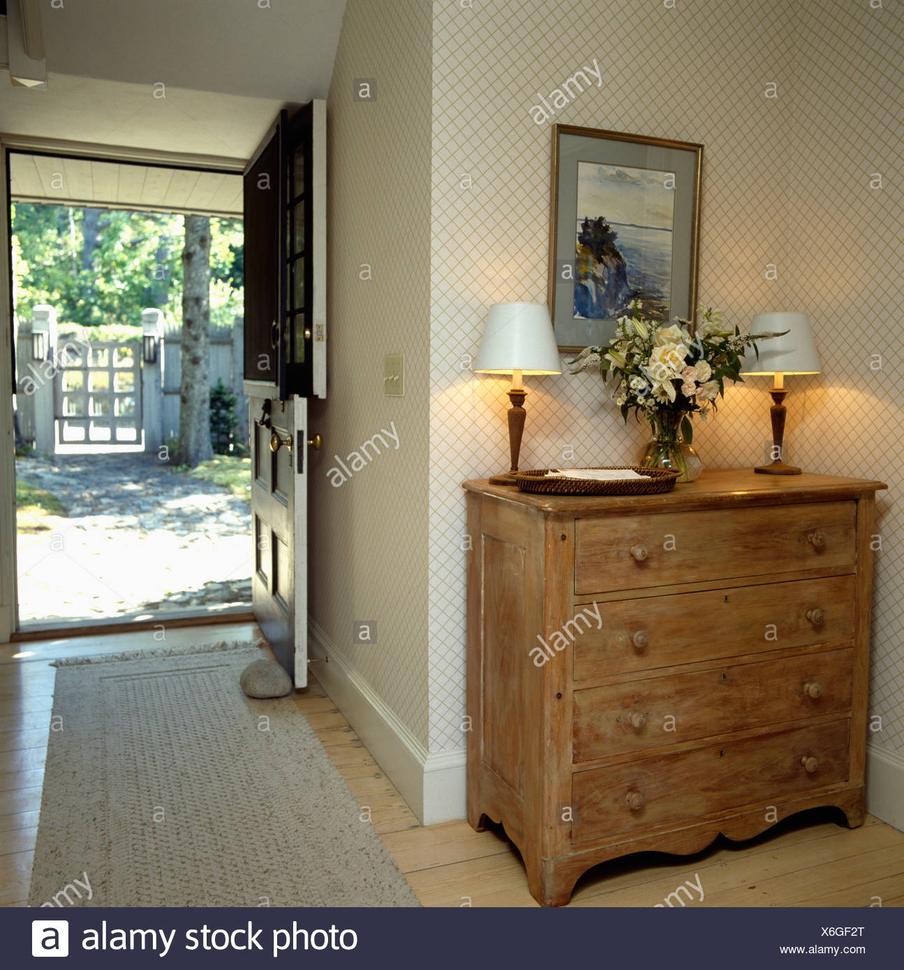 Antique Pine Chest Of Drawers In Country Hall With Lighted Lamps