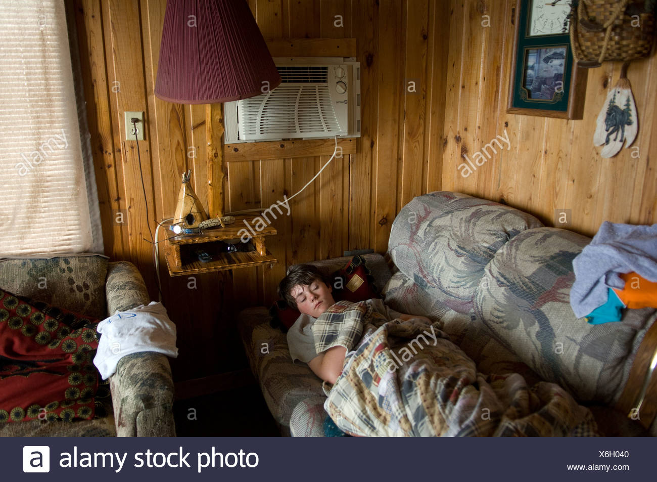 A Teenage Boy Sleeps In A Cabin In Leech Lake Minnesota Stock