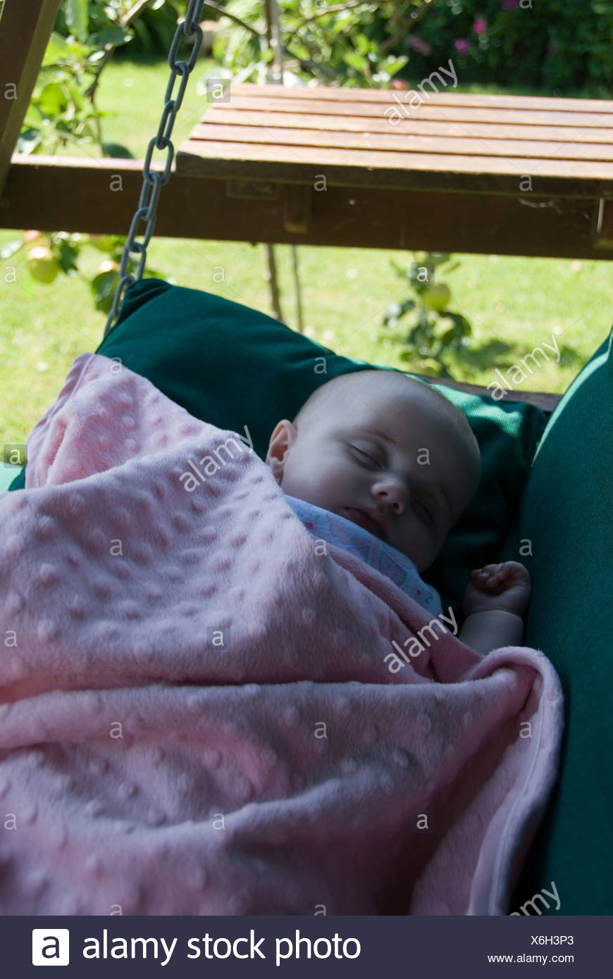 baby sleeping in swing chair