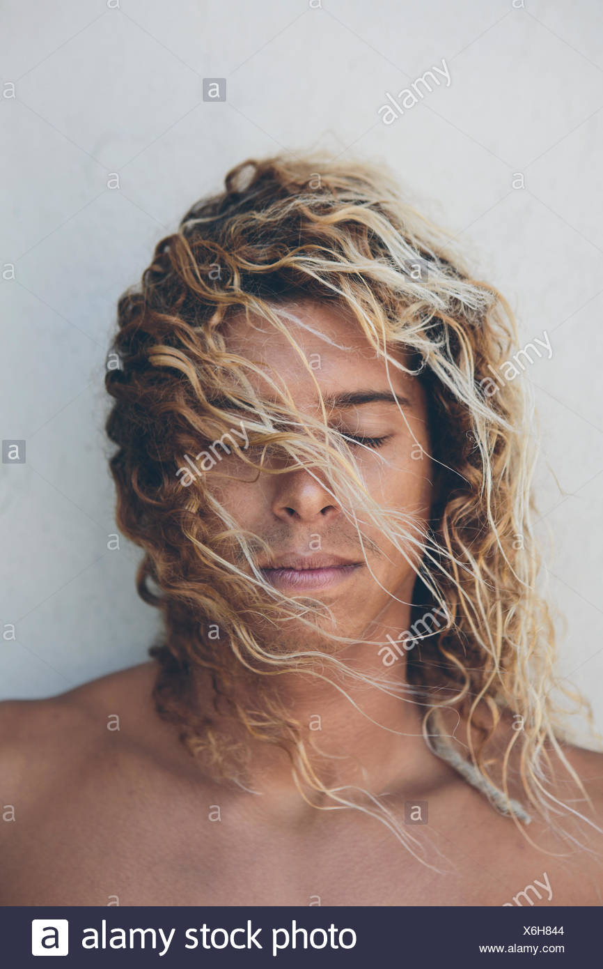 Portrait Of Young Hispanic Surfer With Bleached Blonde Hair Stock