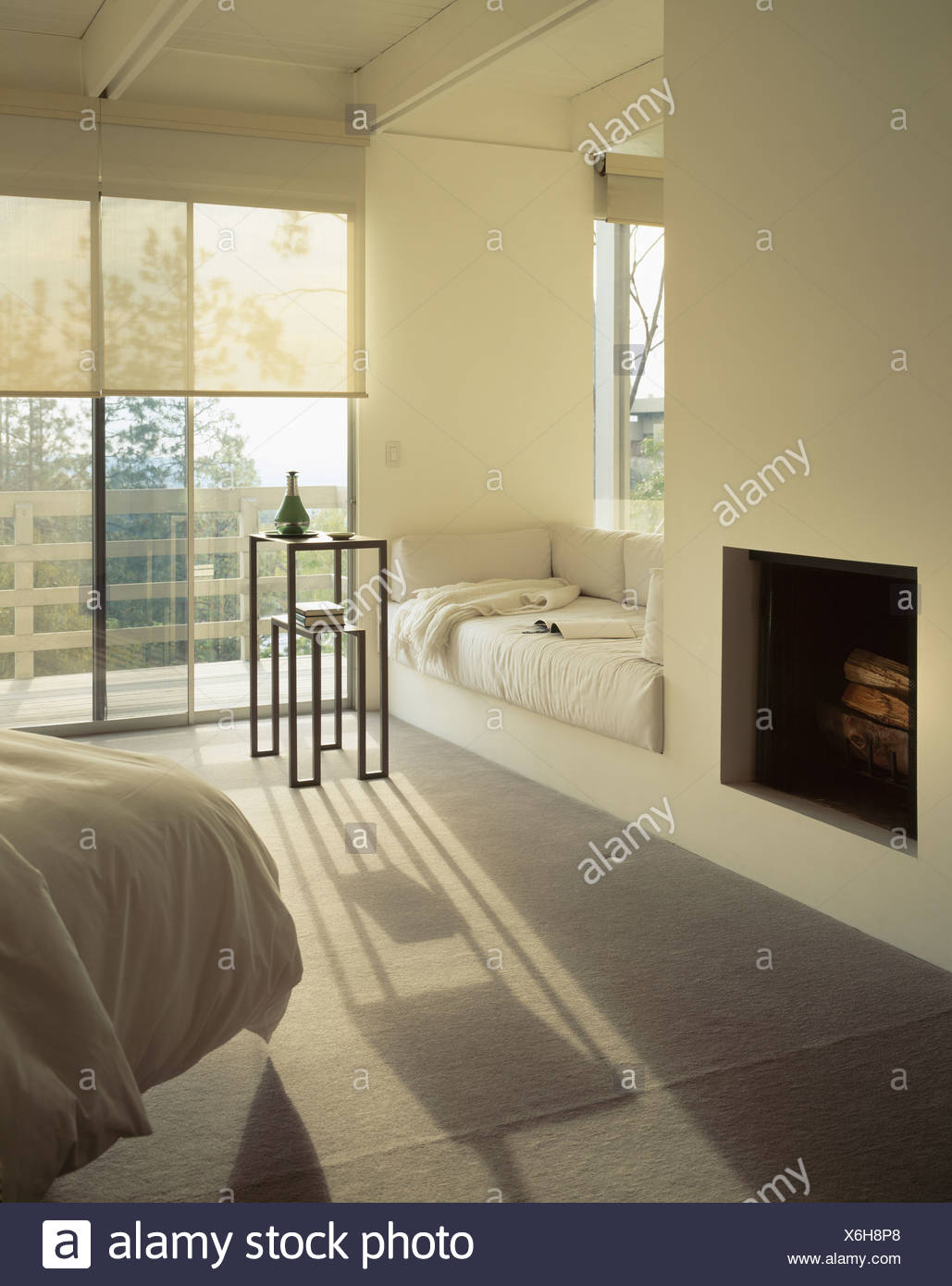 Fireplace And Window Seat With Cream Cushions In Modern White