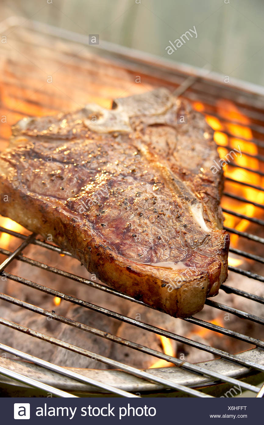 Giant t-bone steak on barbeque grill Stock Photo - Alamy