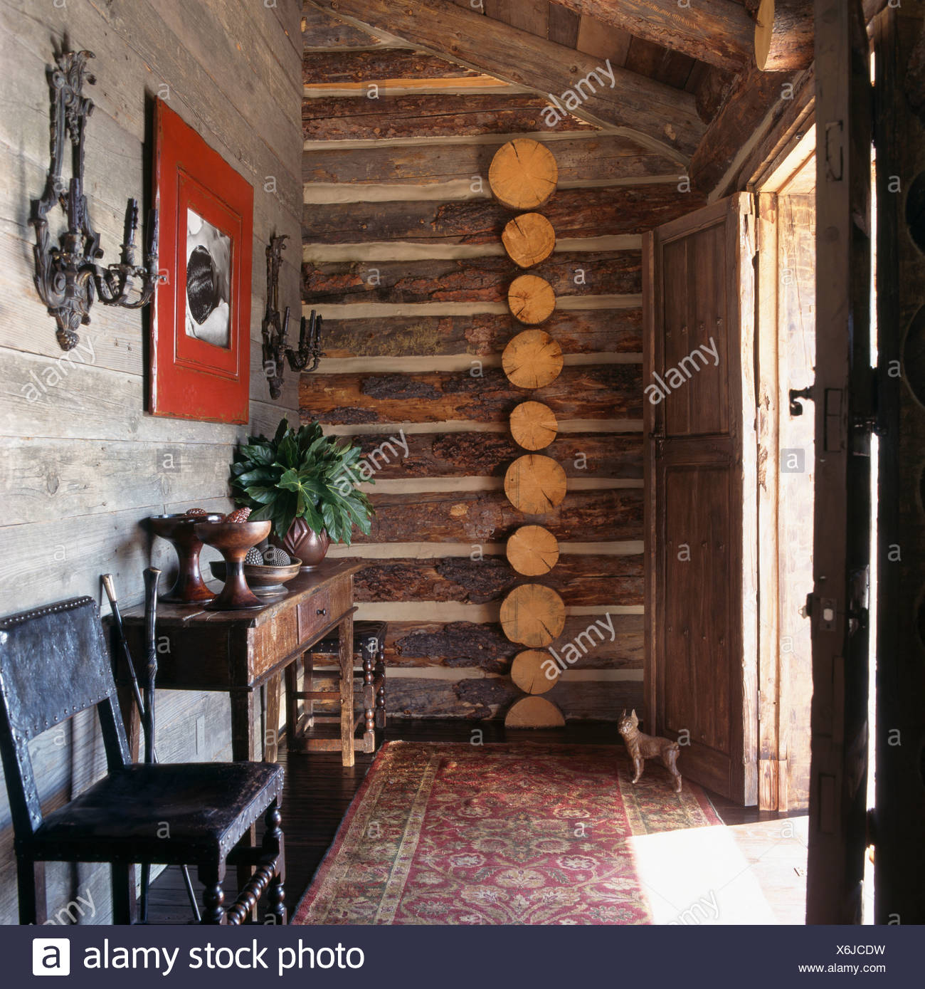 Patterned Rug On The Floor Of Small Hall In Log Cabin With Log