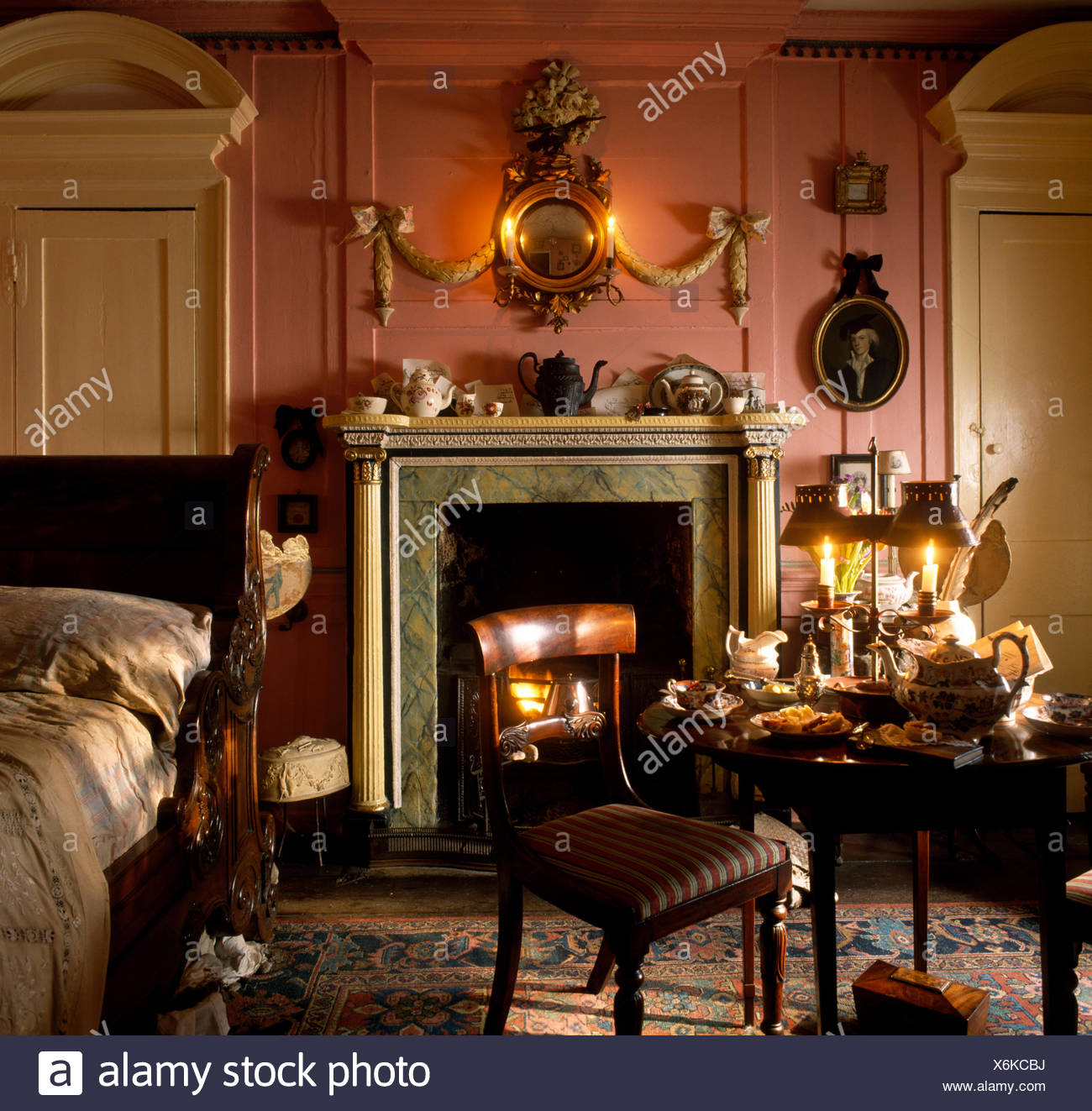 Antique Furniture In A Pink Georgian Bedroom With An Ornate