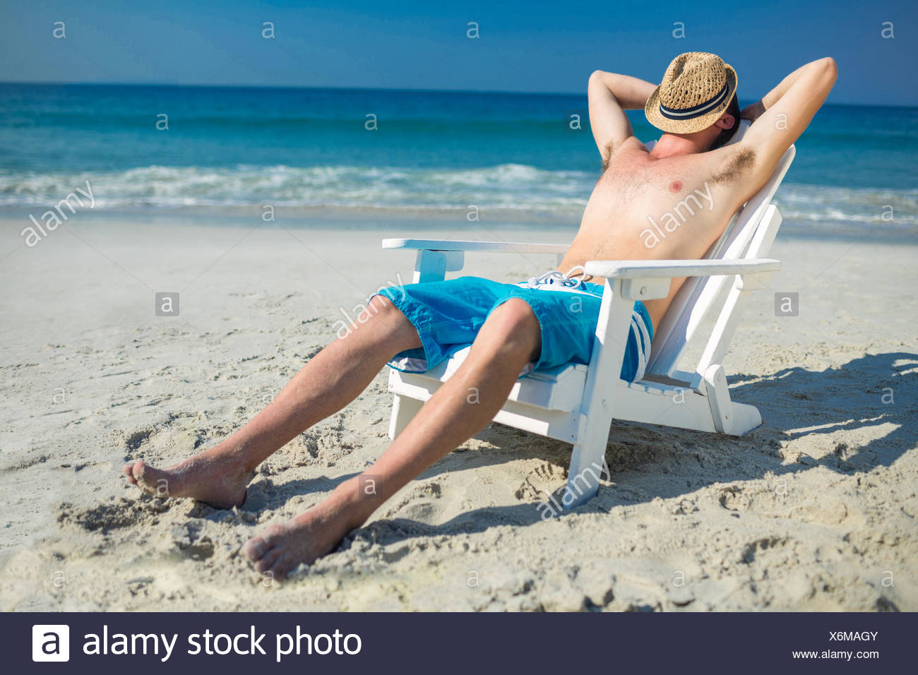 Man Relaxing On Deck Chair At The Beach Stock Photo Alamy