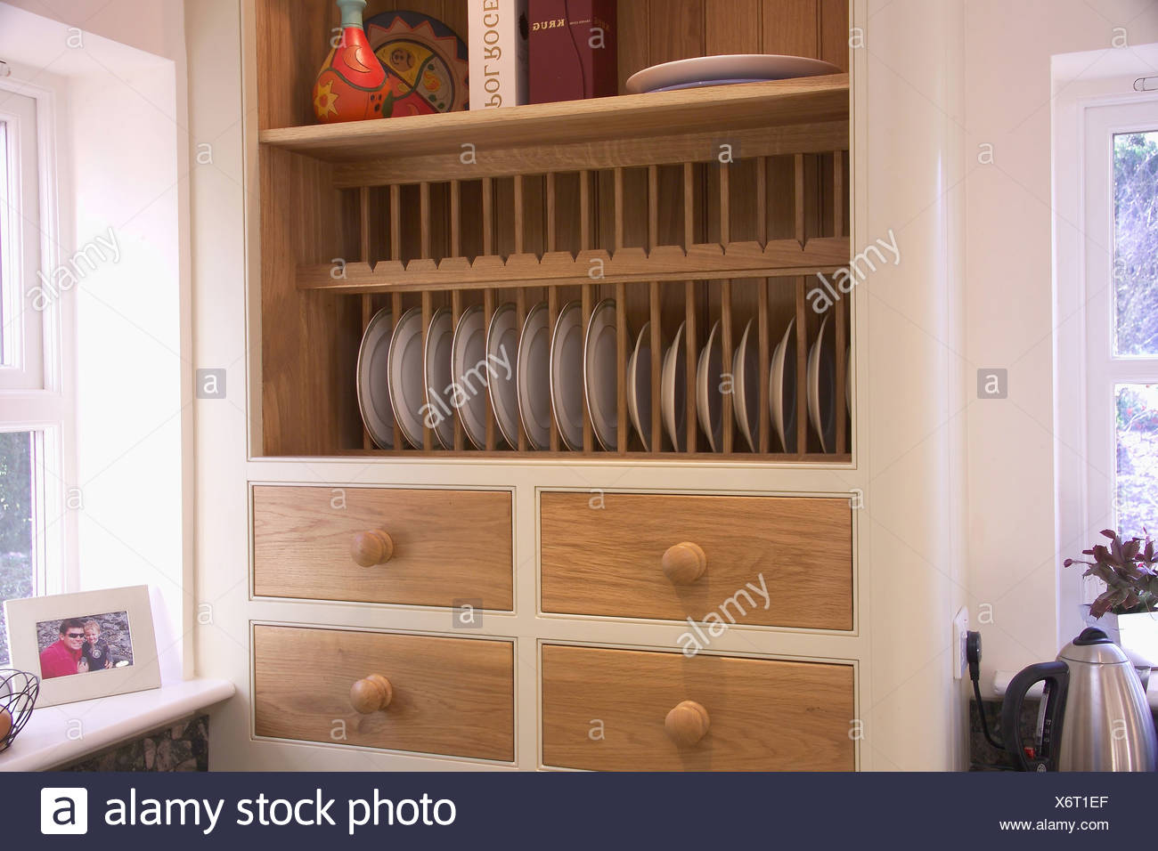 Plate Rack Above Wooden Drawers In Modern Kitchen Unit Stock Photo