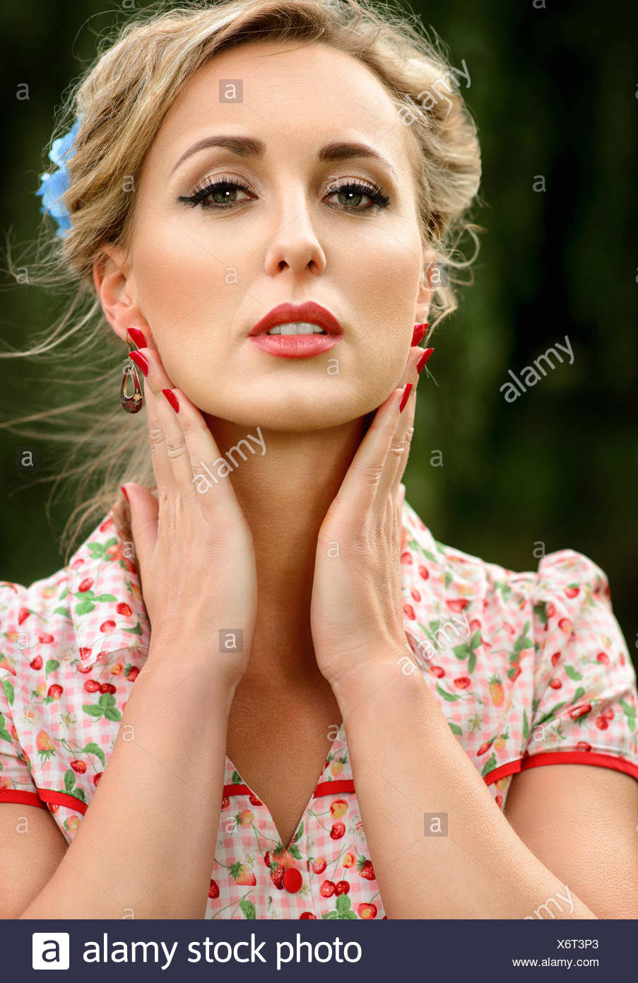 Portrait of a mid adult woman holding her hands to her face Stock Photo