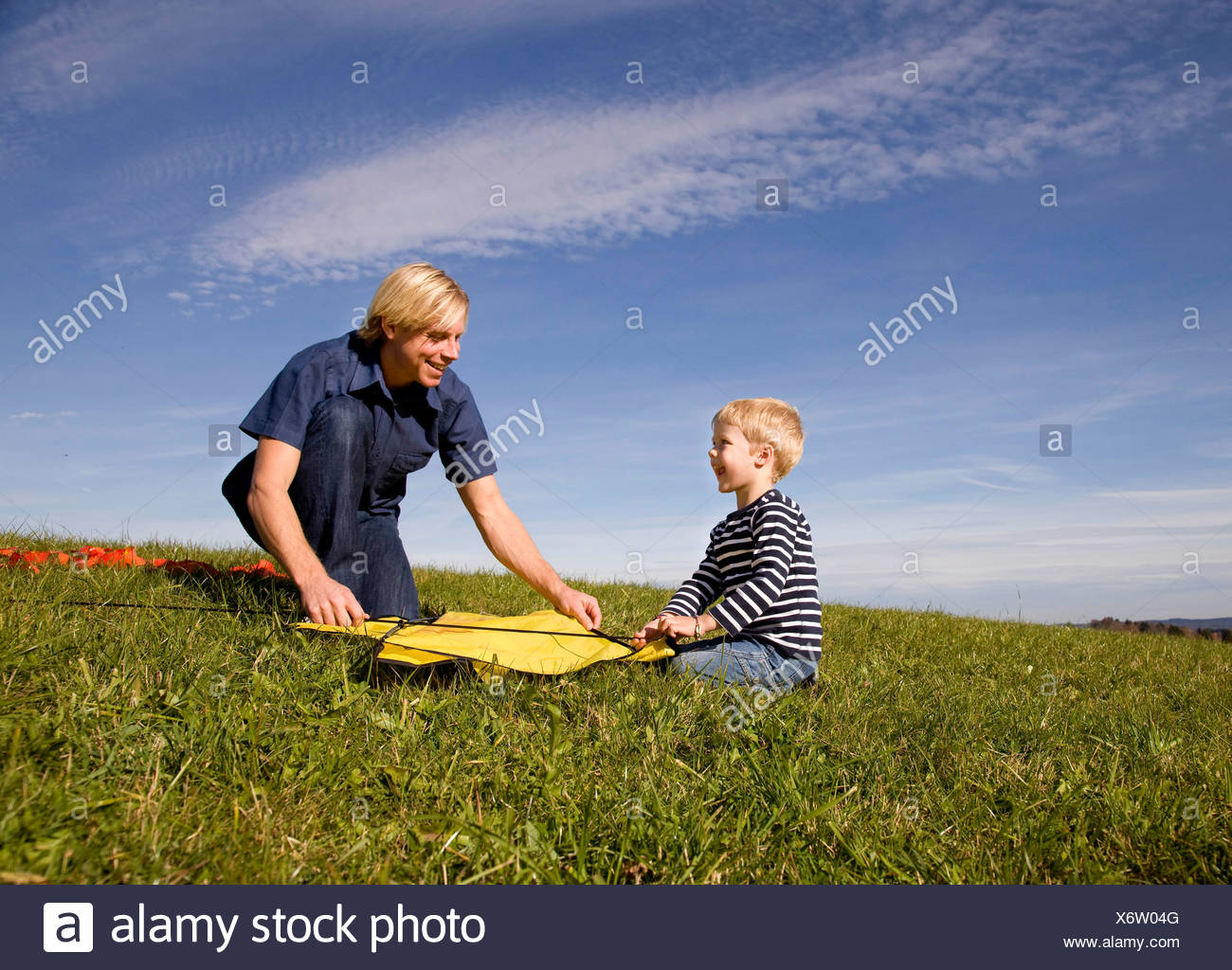 Boy and father put together a Kite Stock Photo