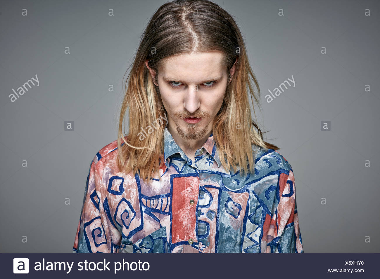 Portrait Of Starring Young Man With Long Blond Hair And Beard
