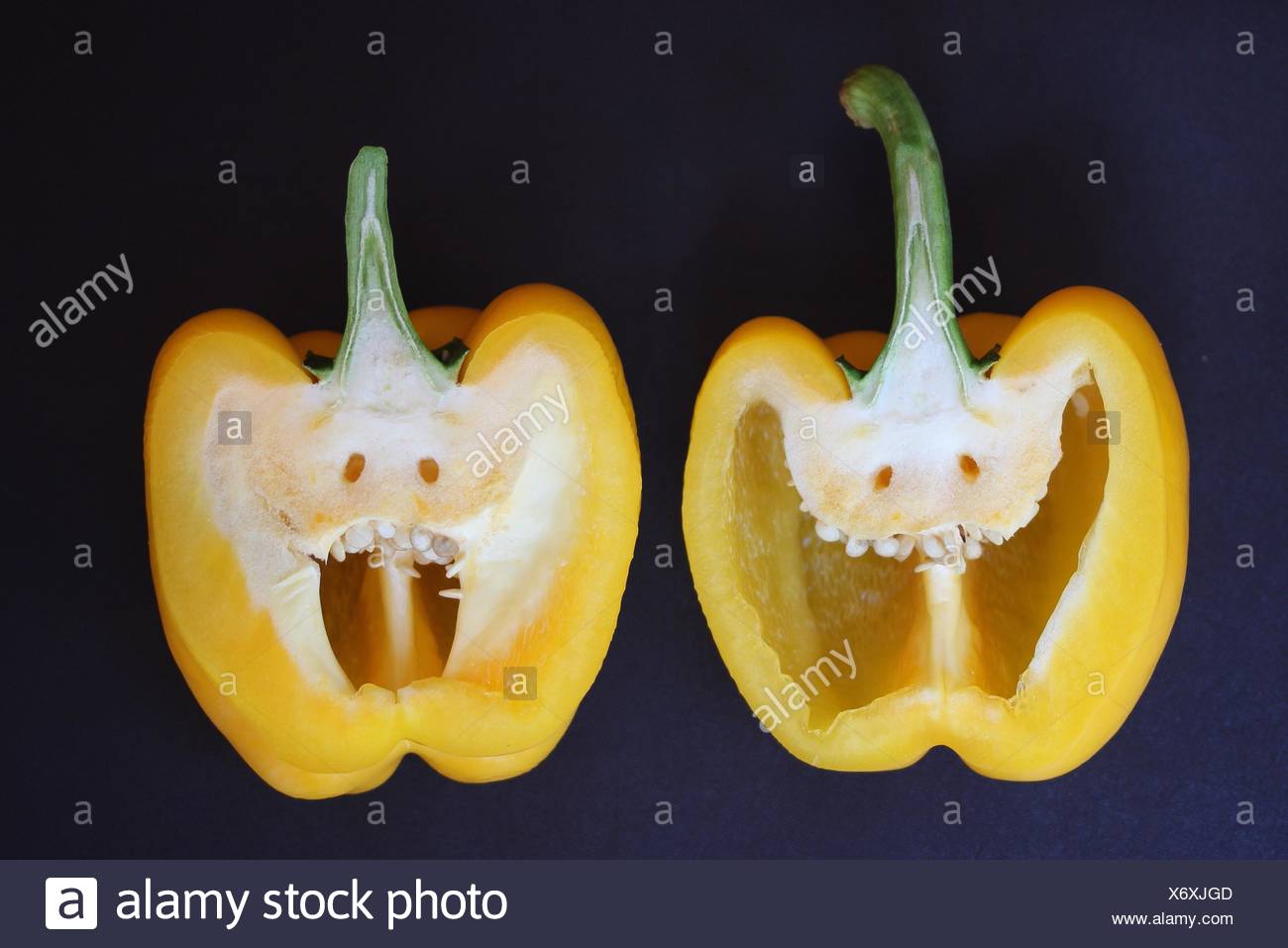 Close-Up Of Halved Yellow Pepper With Anthropomorphic Face Stock Photo