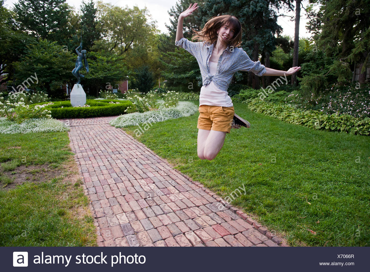 A Teenager Jumps In Excitement At The Sunken Gardens In Lincoln