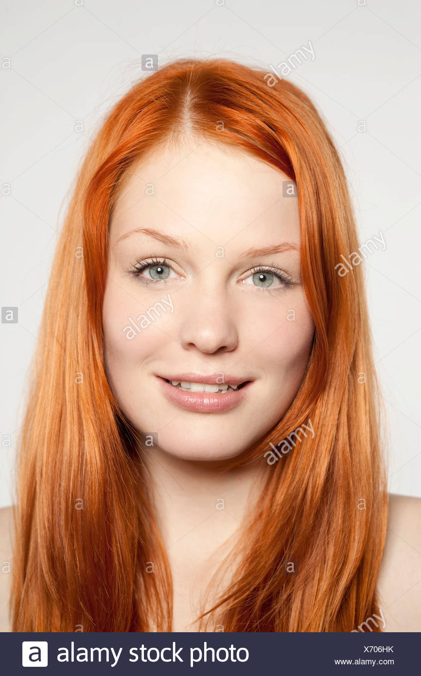 Portrait Of A Friendly Smiling Young Red Haired Woman In Front