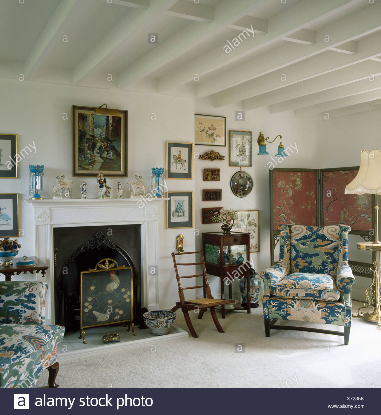 Blue Patterned Armchair Beside Fireplace In White Living