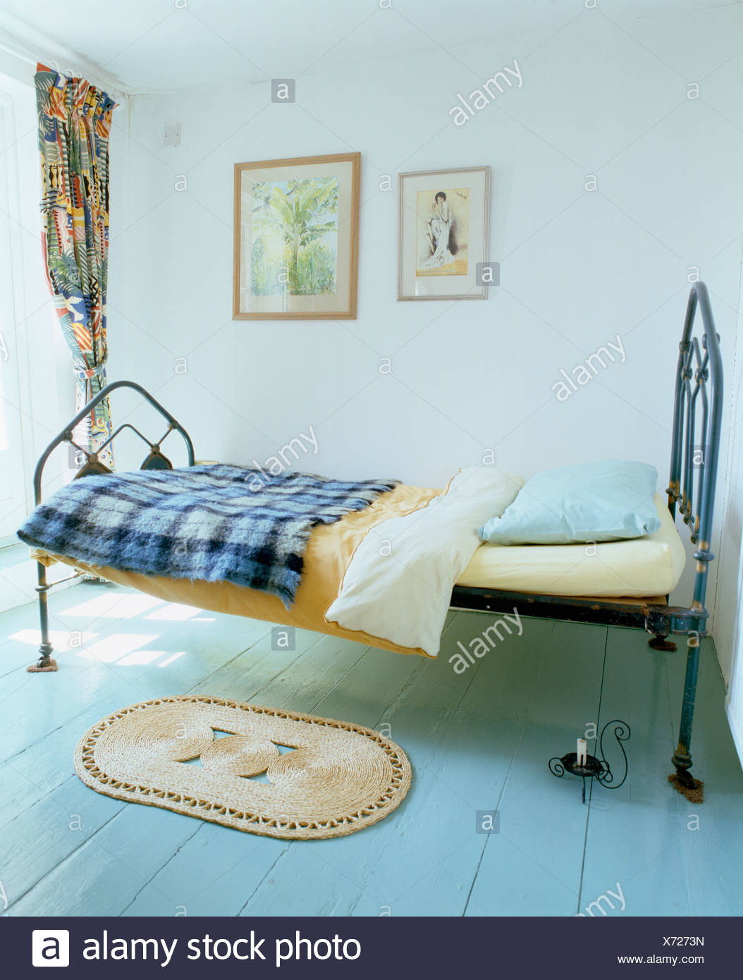 Blue Checked Blanket On Single Black Cast Iron Bed In Simple