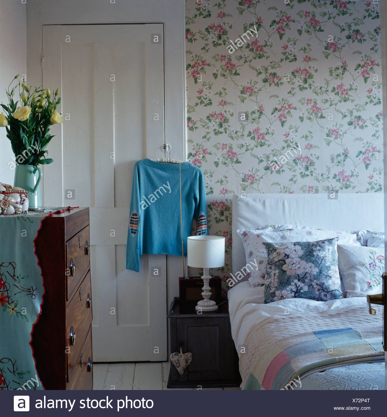 Floral Wallpaper In Country Bedroom With Blue White Cushions On