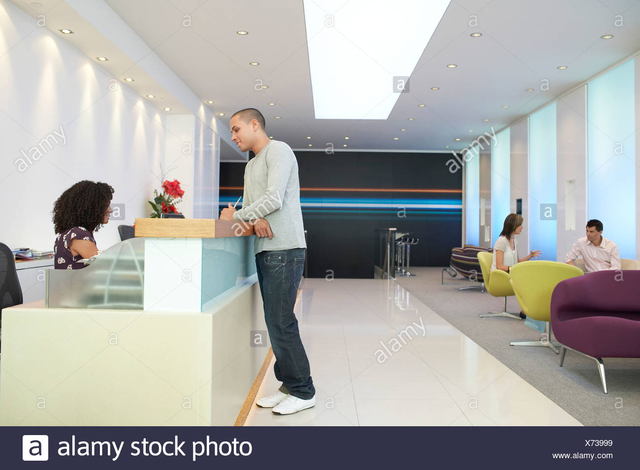 Man Standing Reception Desk Talking High Resolution Stock Photography