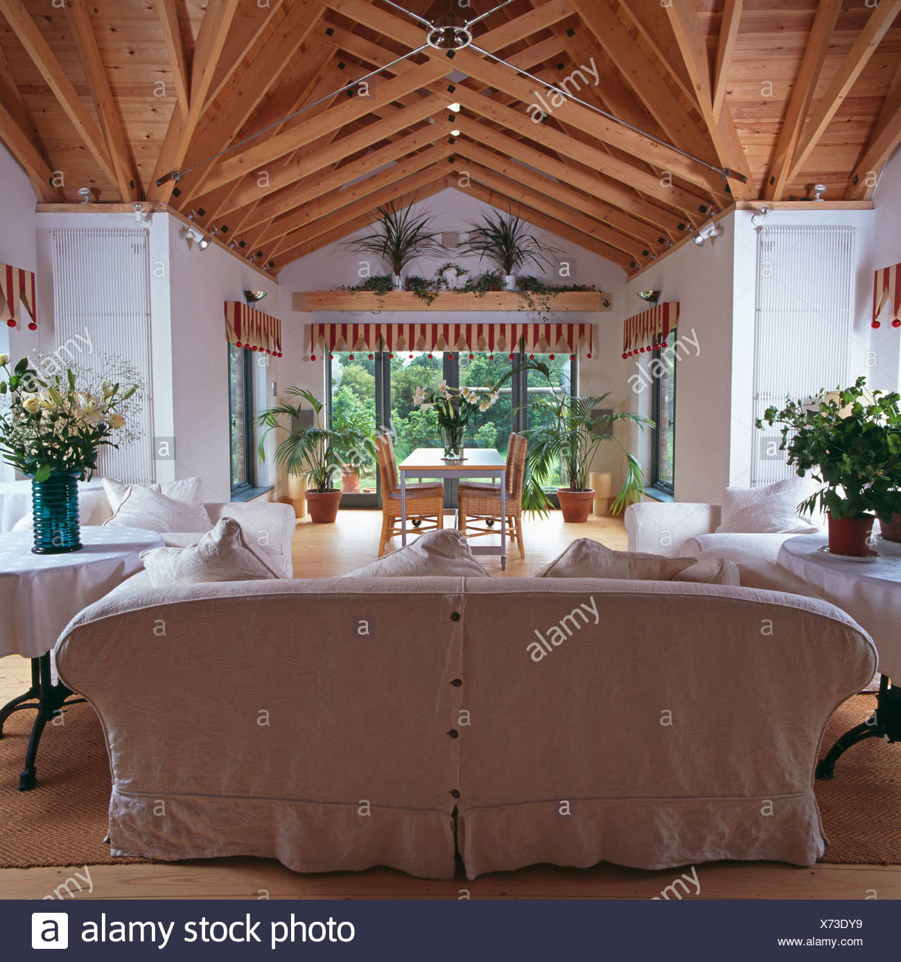 White Loose Cover On Sofa In Large Living And Dining Room