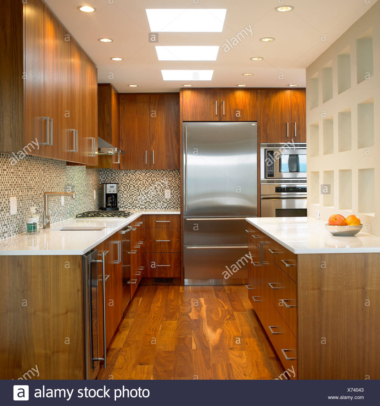 Kitchen With Walnut Cabinets And Corian Countertops Stock Photo