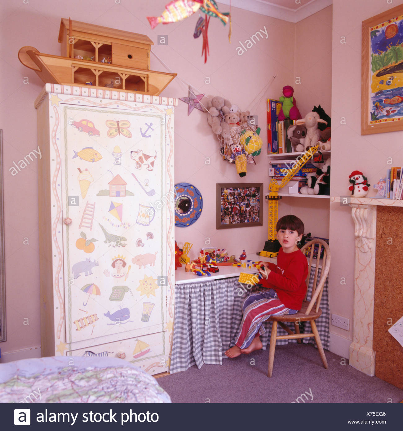 Portrait Of A Small Boy Playing With Lego In His Bedroom