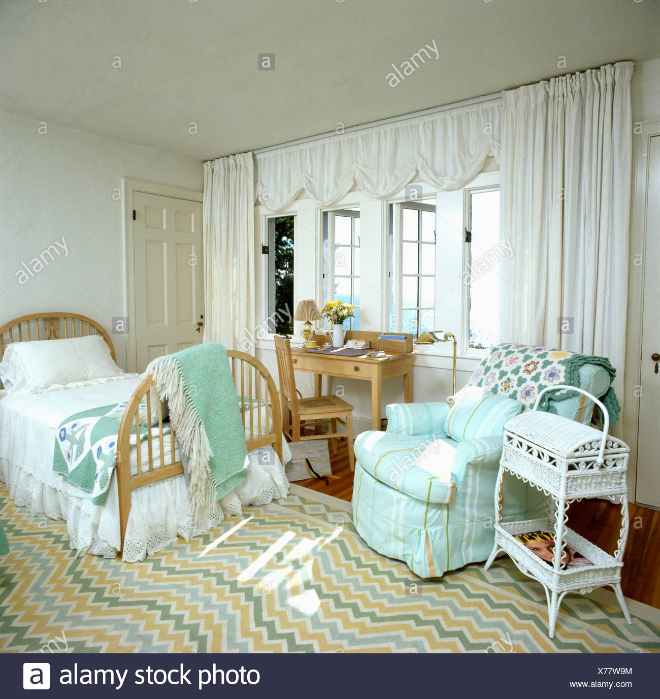 Seaside Bedroom With Turquoise Loosecover On Armchair And