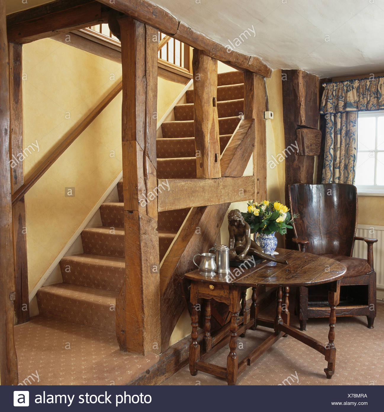Circular Antique Table And Orkney Chair Beside Wooden Staircase In