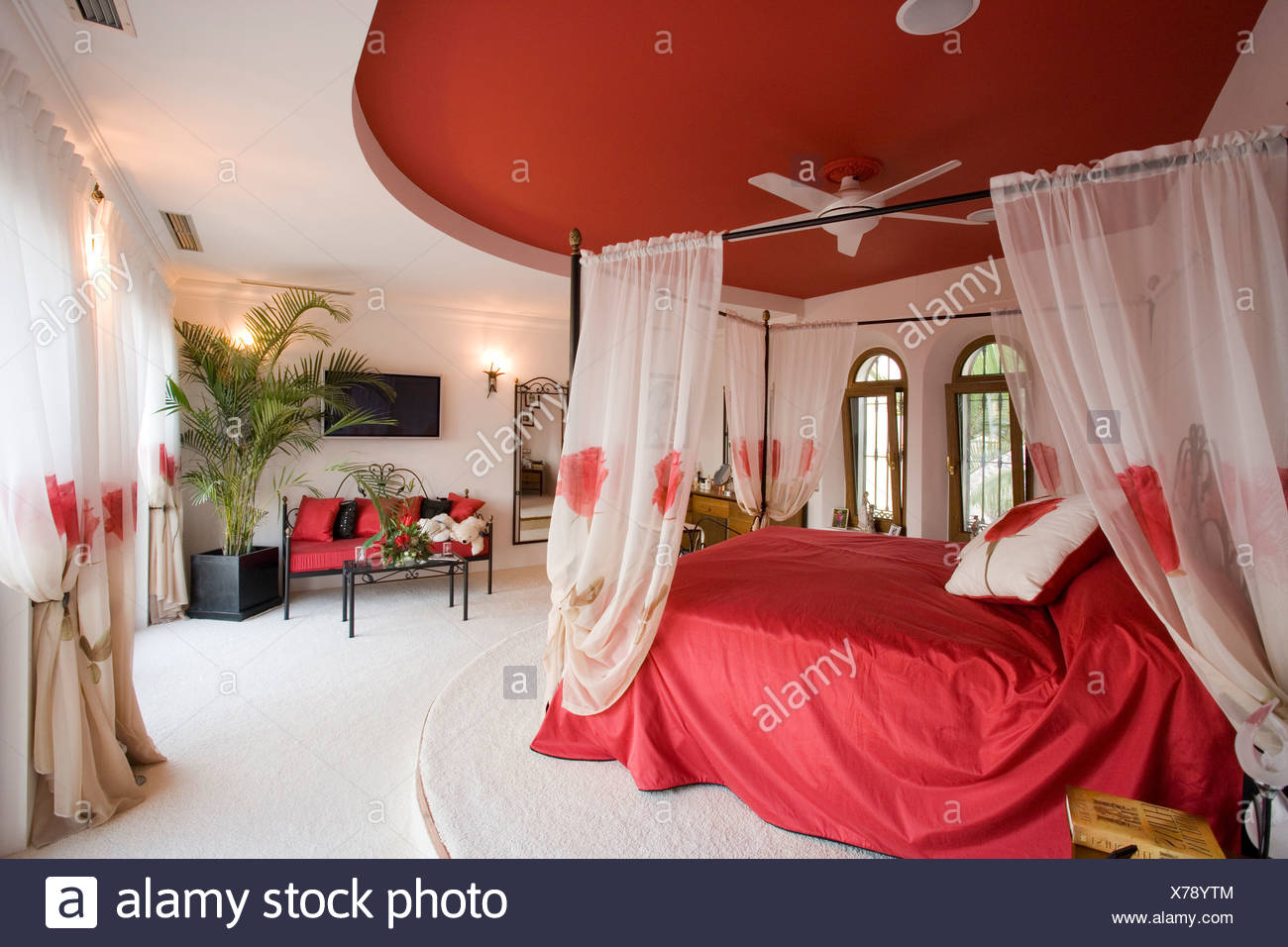 Red Ceiling Above Bed With White Voile Drapes And Red