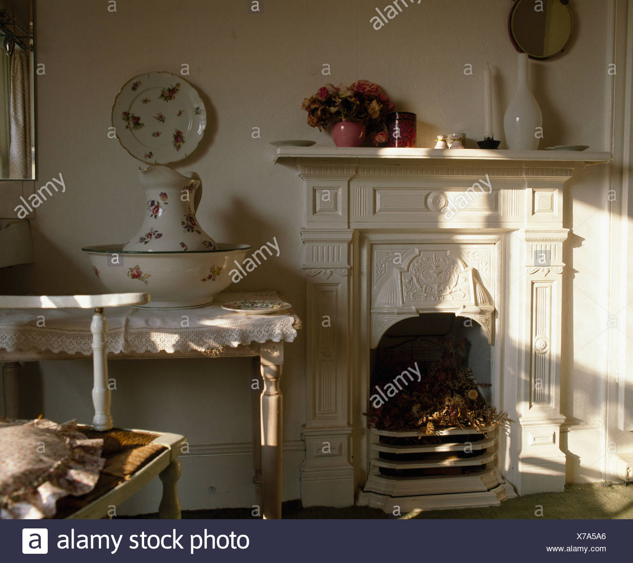 White Victorian Fireplace In Bedroom With Large Jug And Basin On
