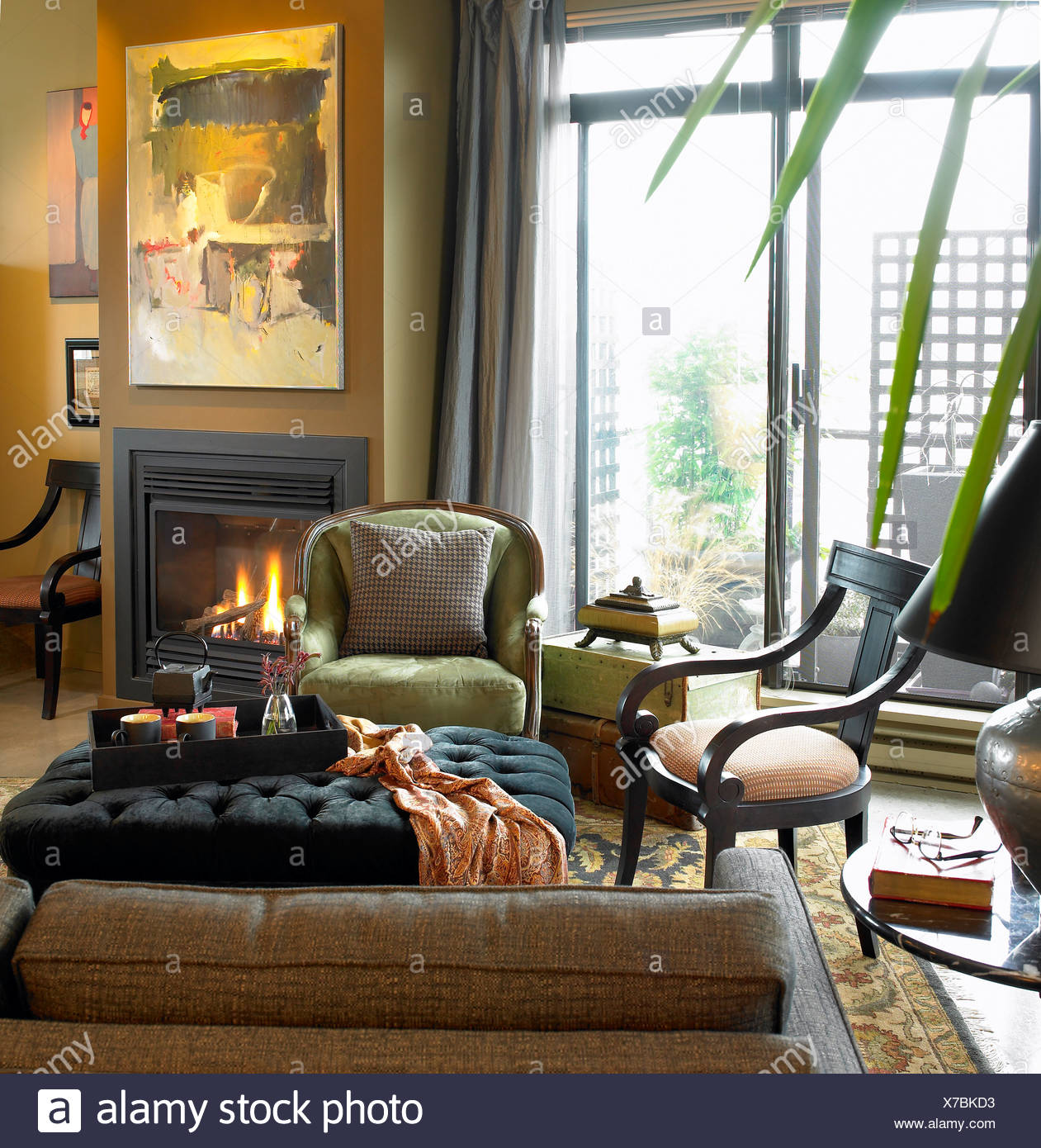 Condo Living Room With Fireplace Burning And Patio Doors