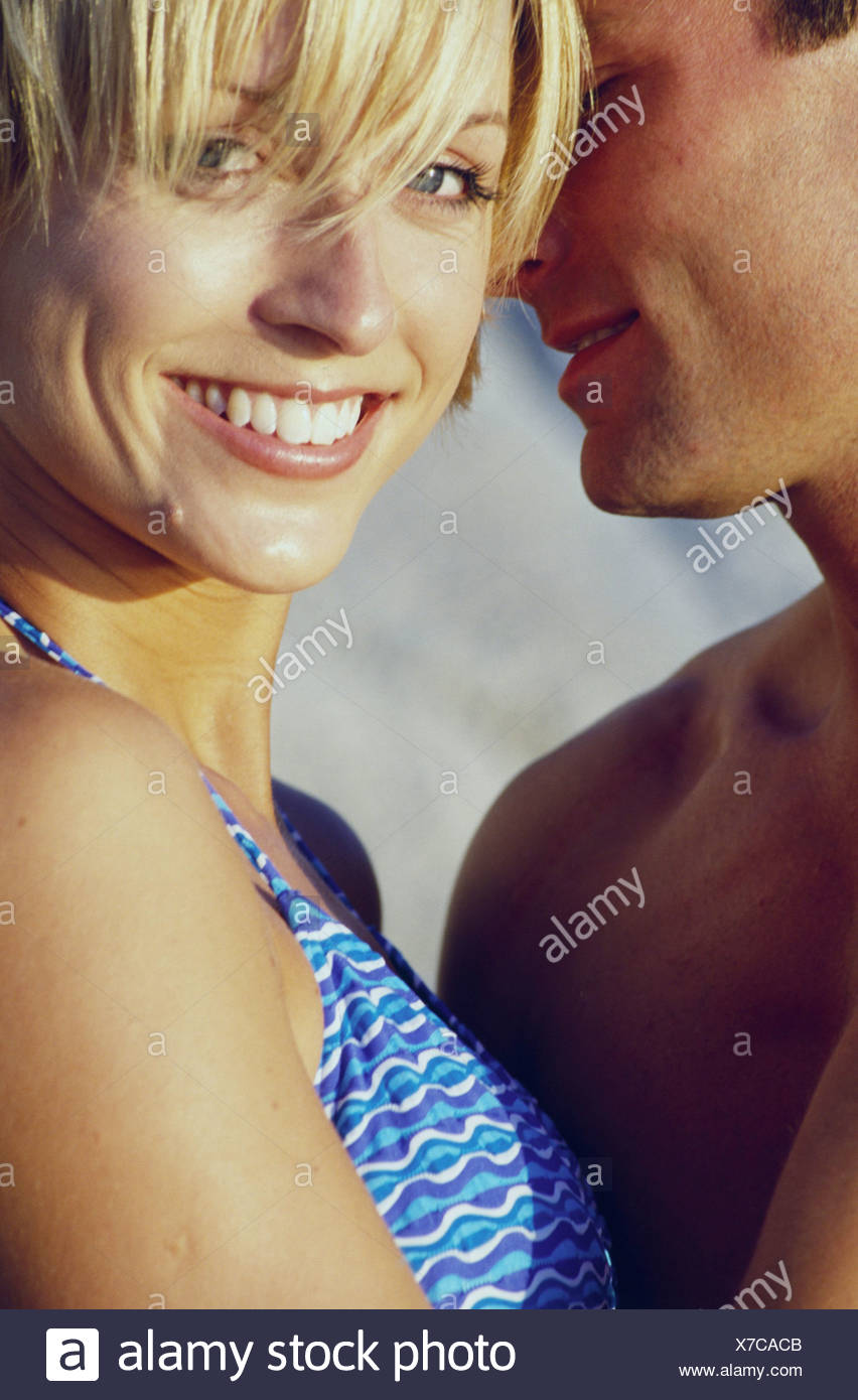 Female With Short Blonde Hair Wearing Blue Bikini Male With Short