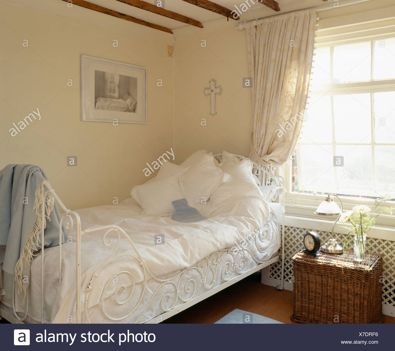 White Pillows And Bedlinen On Ornate White Cast Iron Single