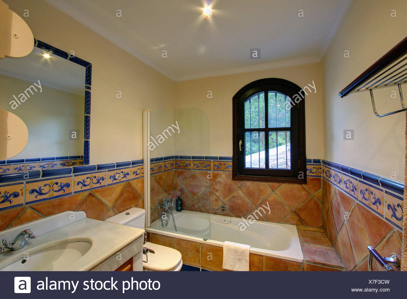 Window Above Bath In Spanish Bathroom With Traditional Terracotta