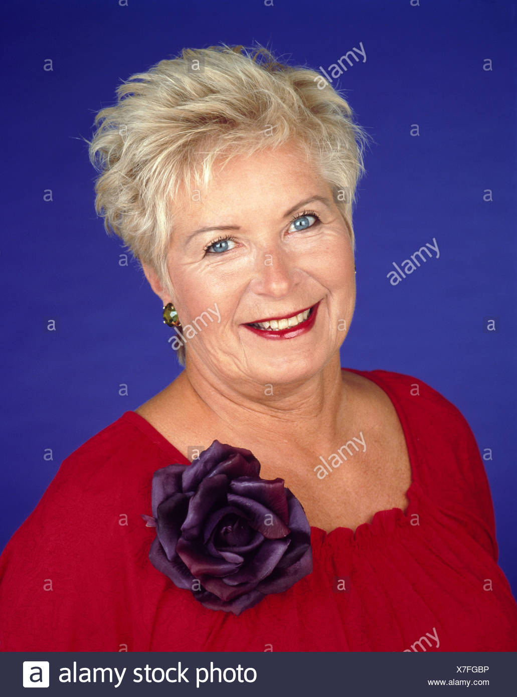 Female Short Blonde Hair Wearing A Red Top Decorated Purple