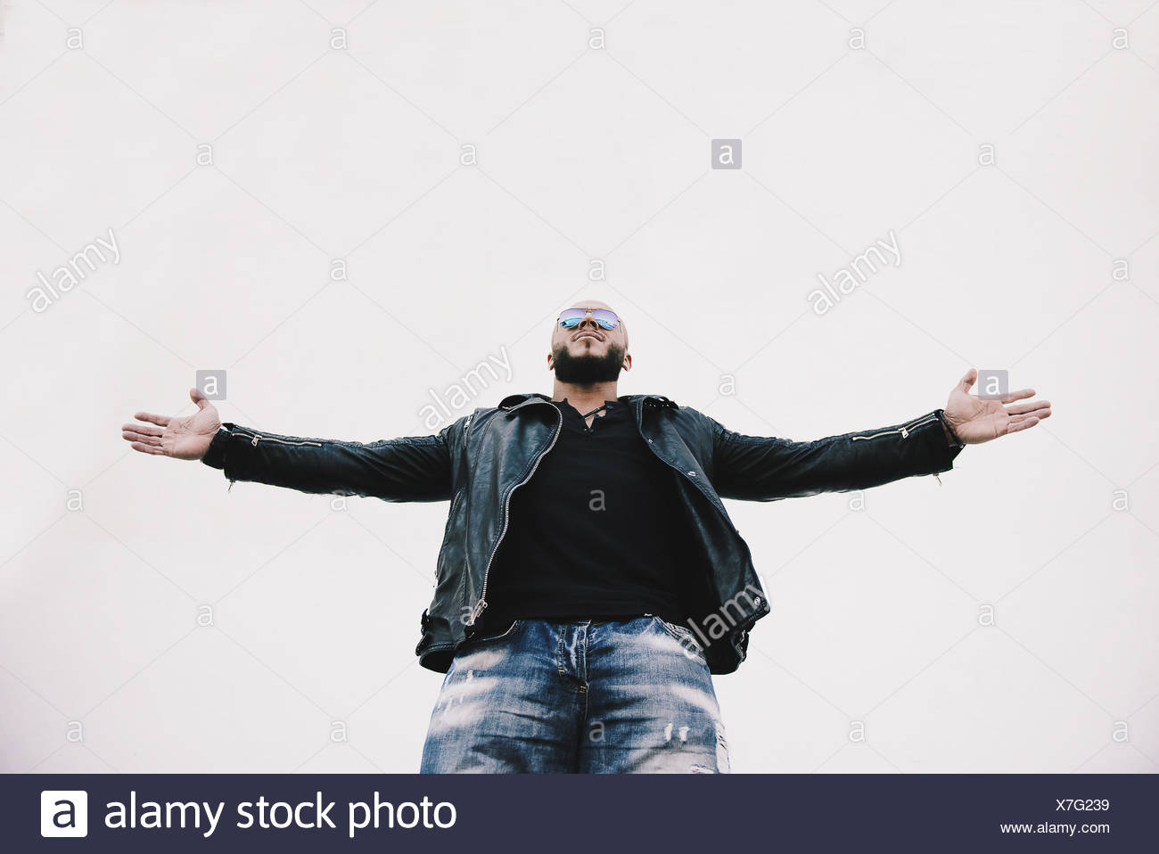 Low angle view of a cool man with arms outstretched Stock Photo